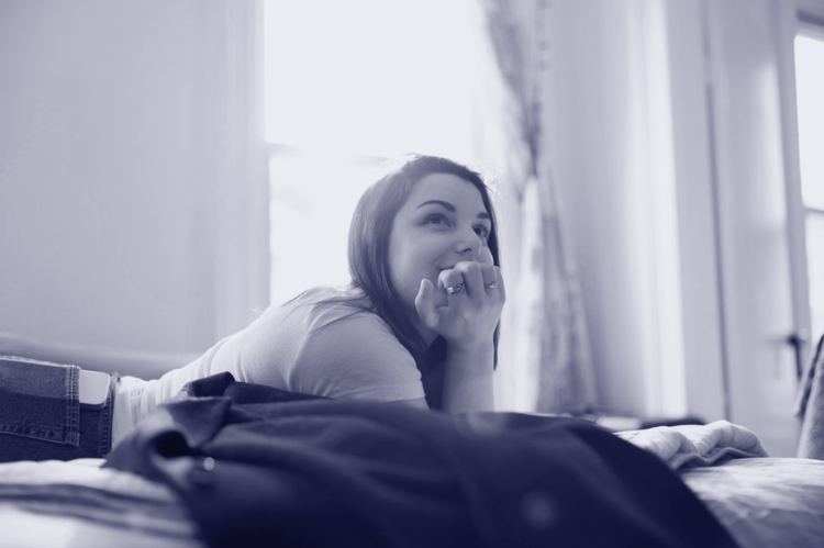 Woman resting her head on her chin thoughtfully