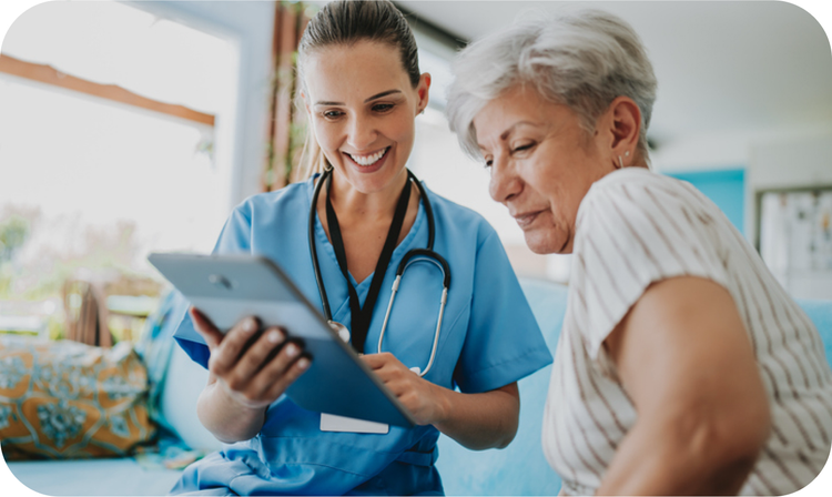 A healthcare worker showing a woman a tablet